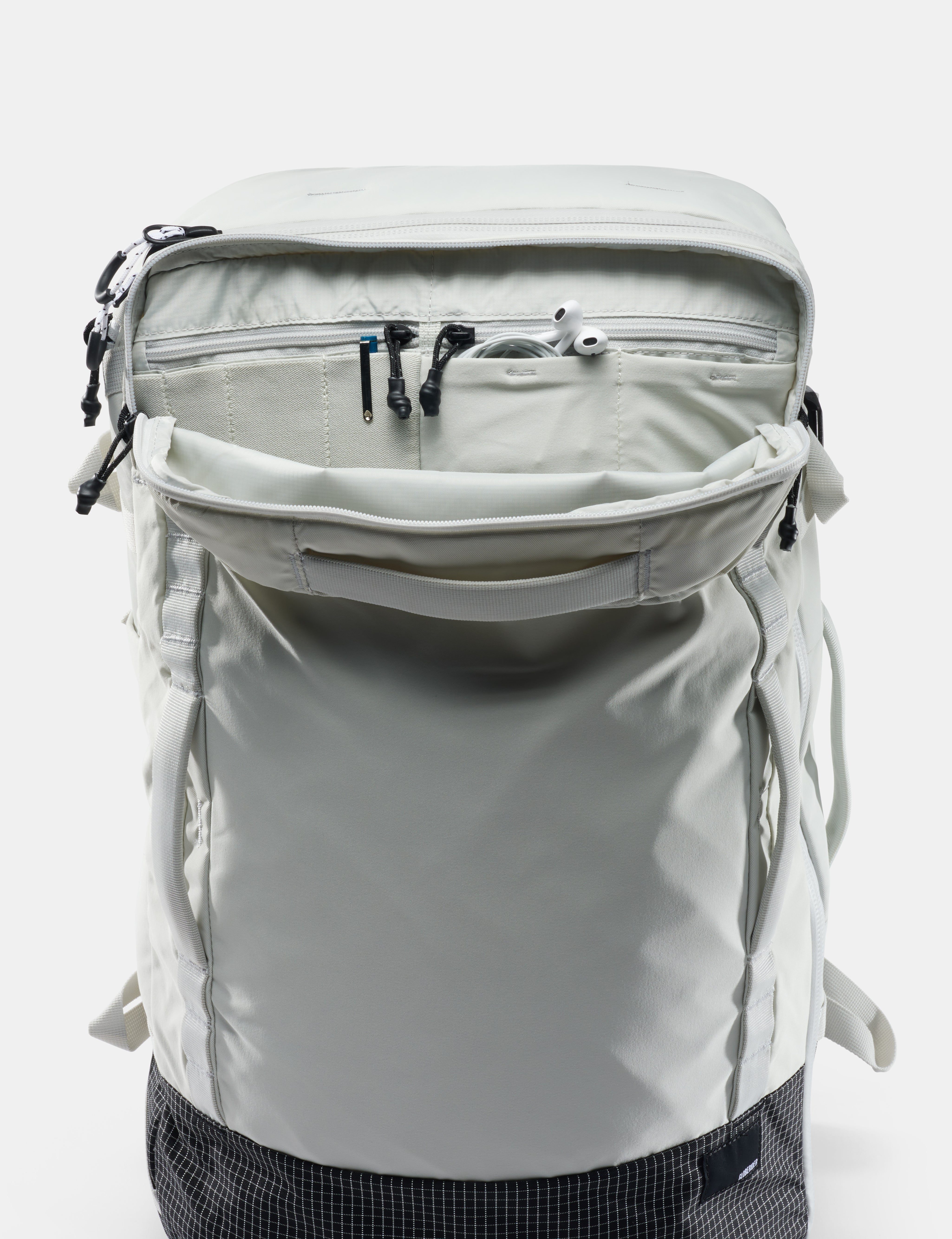 Light gray backpack with multiple zippers on a white background