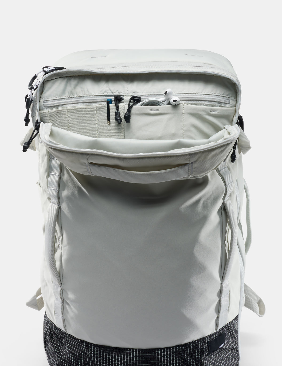 Light gray backpack with multiple zippers on a white background
