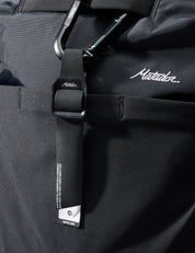 Close-up of a black bag with a strap featuring the Matador logo.