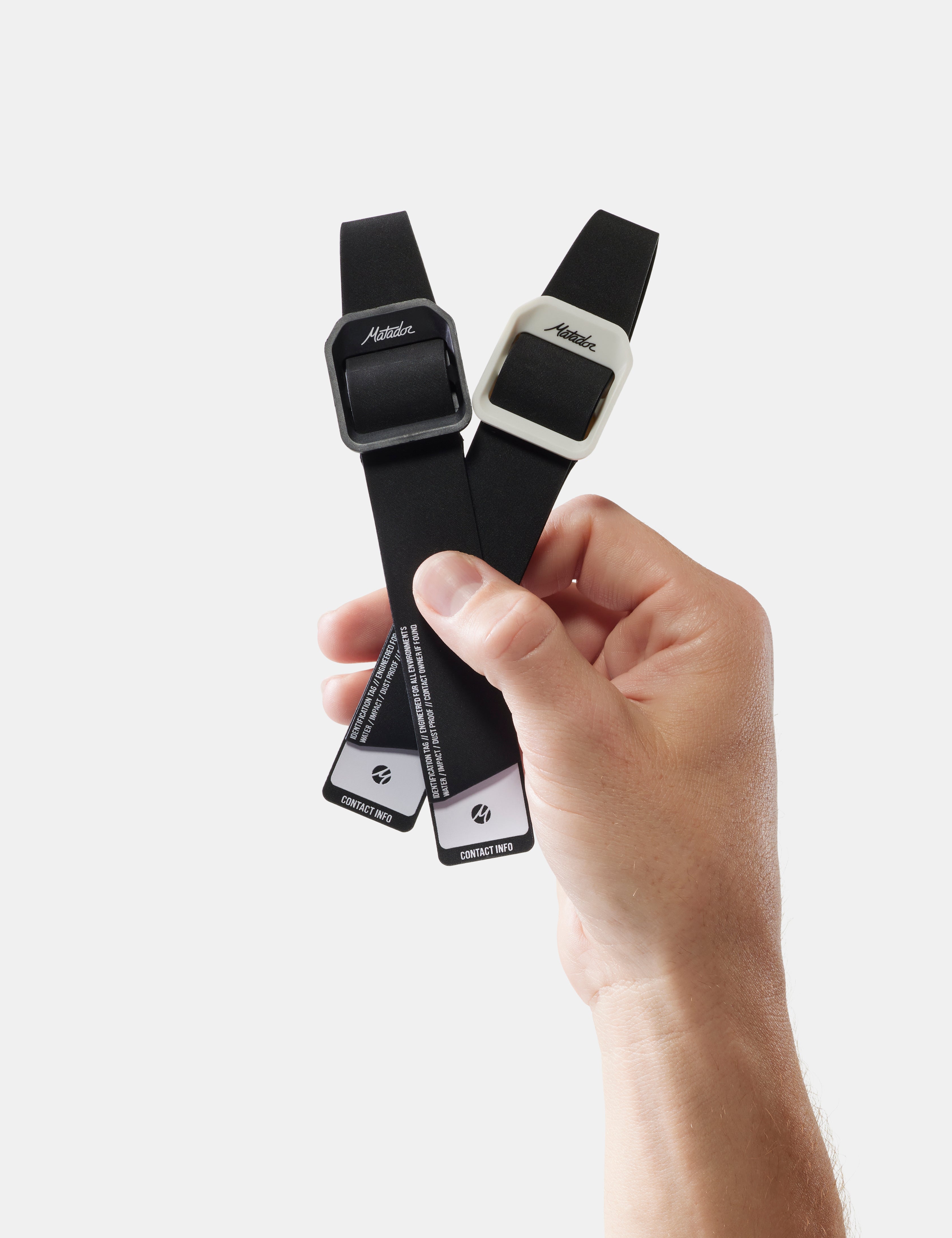 hand holding 2 gear tags on white background