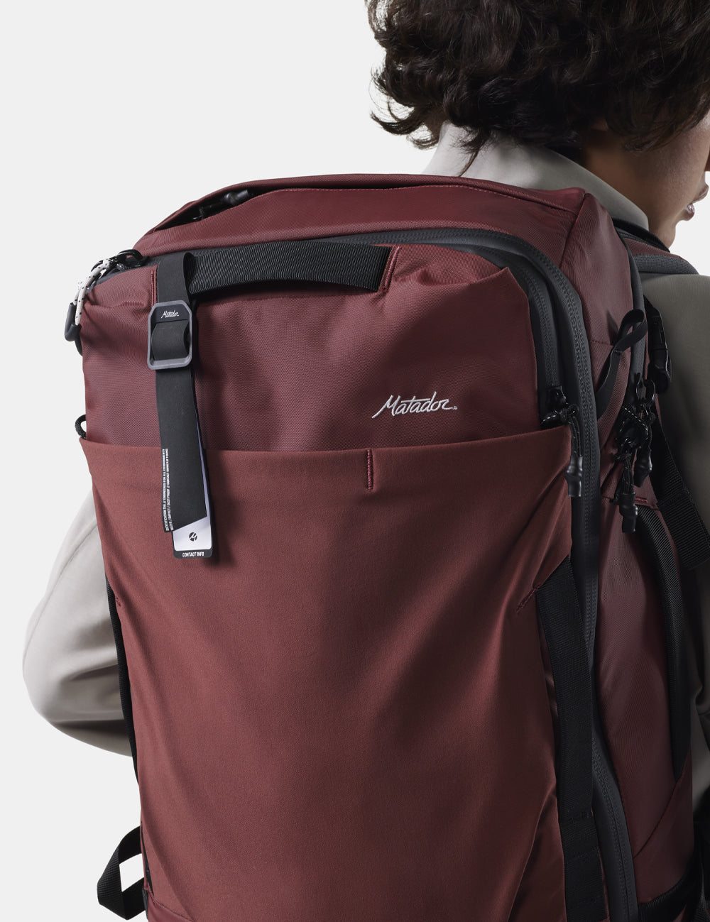 gear tag hanging off garnet bag