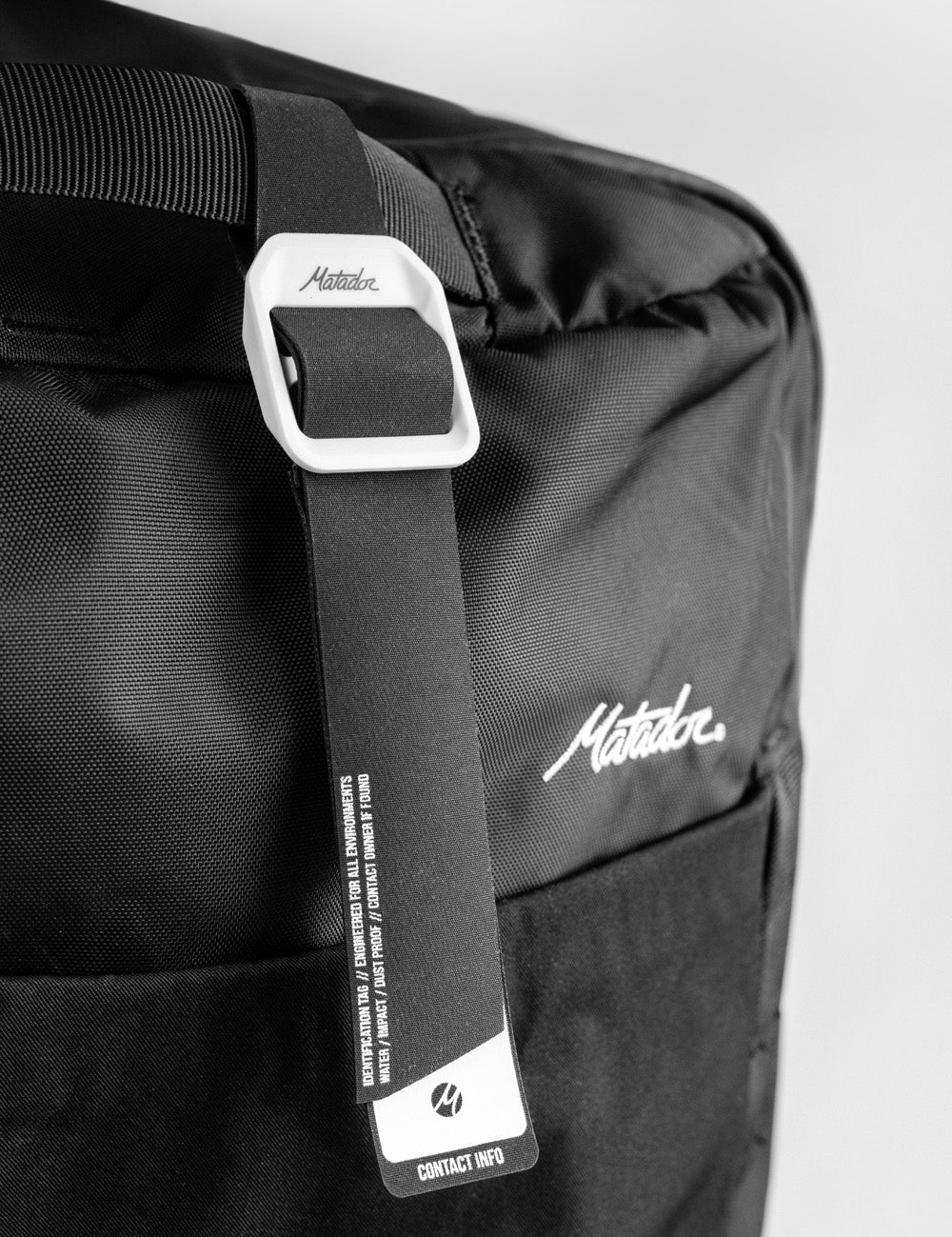 gear tag hanging off black bag