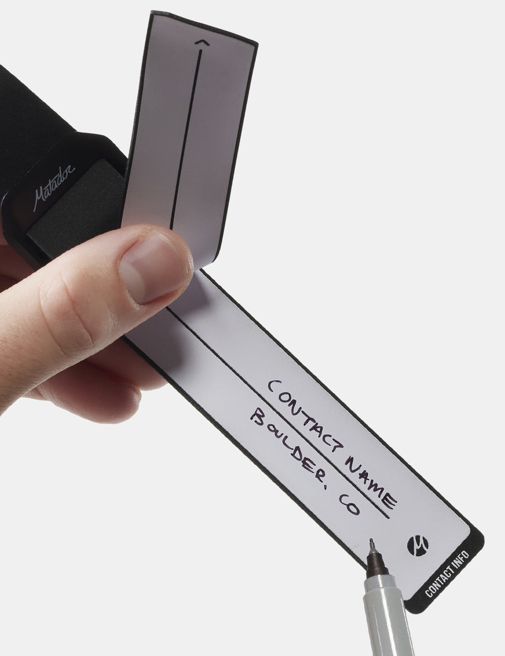 sharpie writing on gear tag &quot;contact name, boulder, co&quot;
