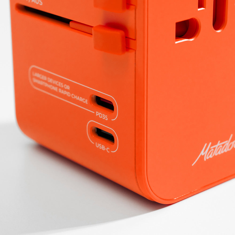 close up view of PD35 and USB-C ports on orange travel adapter