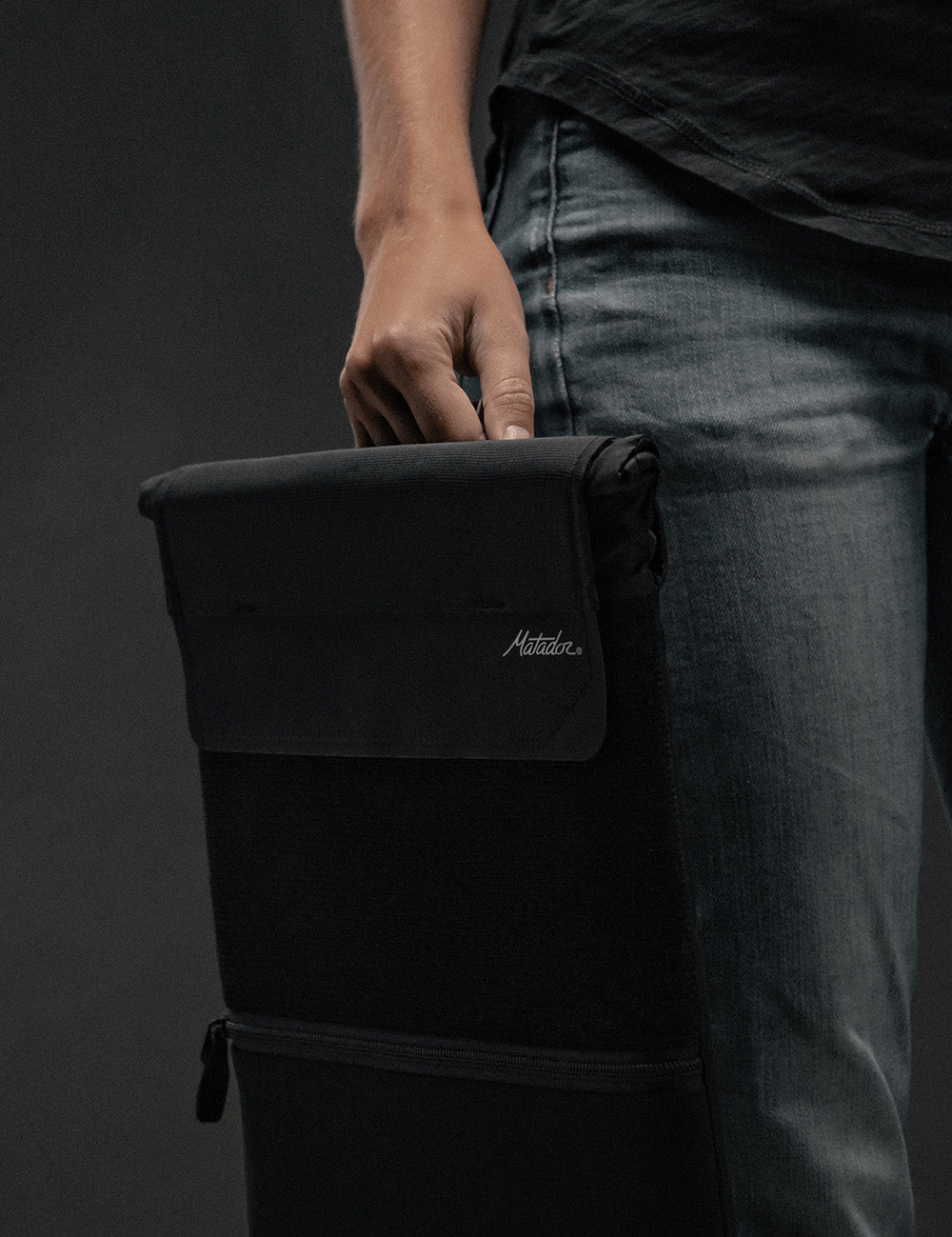 hand holding laptop base layer from top handle