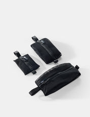 Three black pouches of varying sizes on a white background