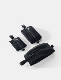 Three black pouches of varying sizes on a white background