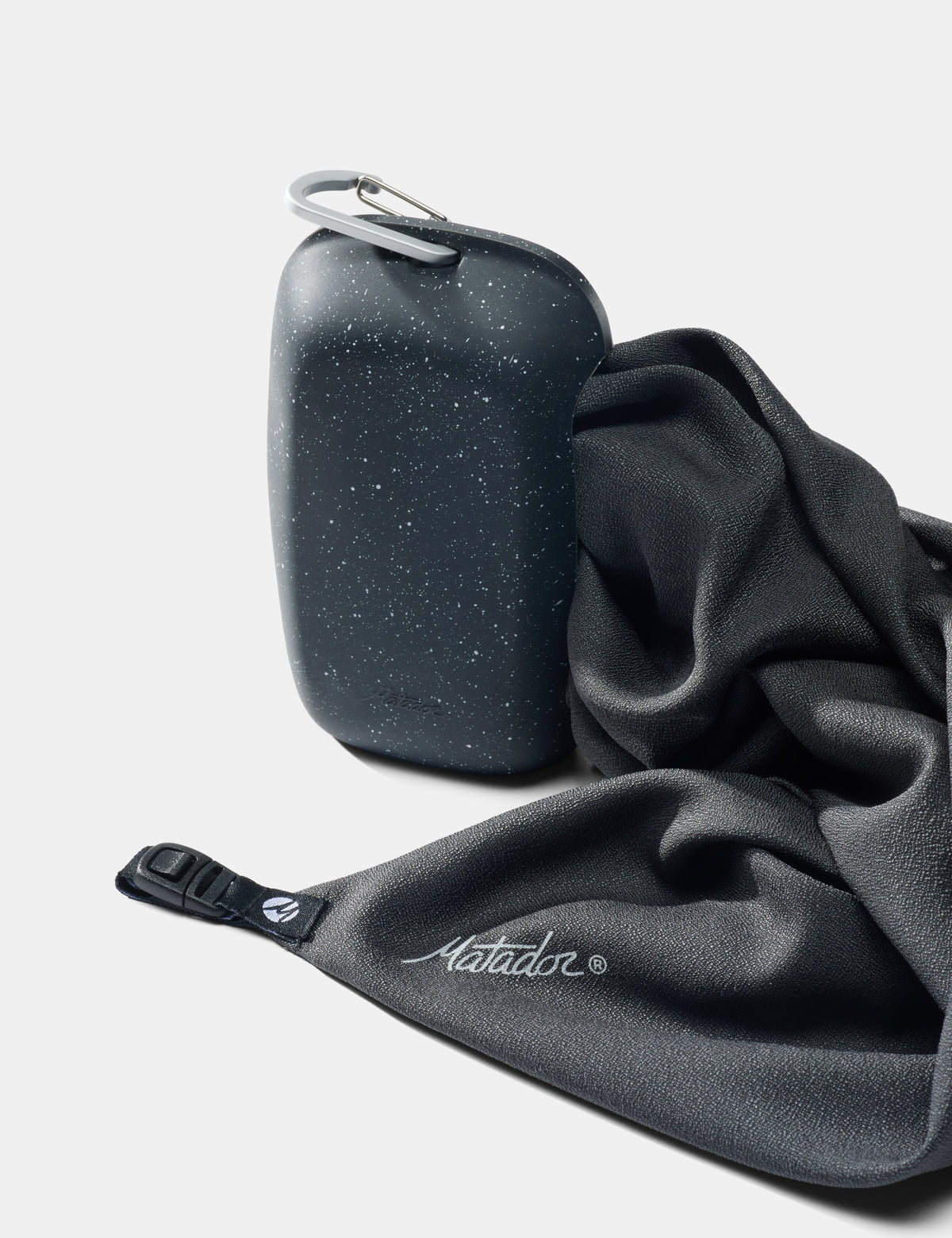 Nanodry towel being pulled out of silicone case on white background