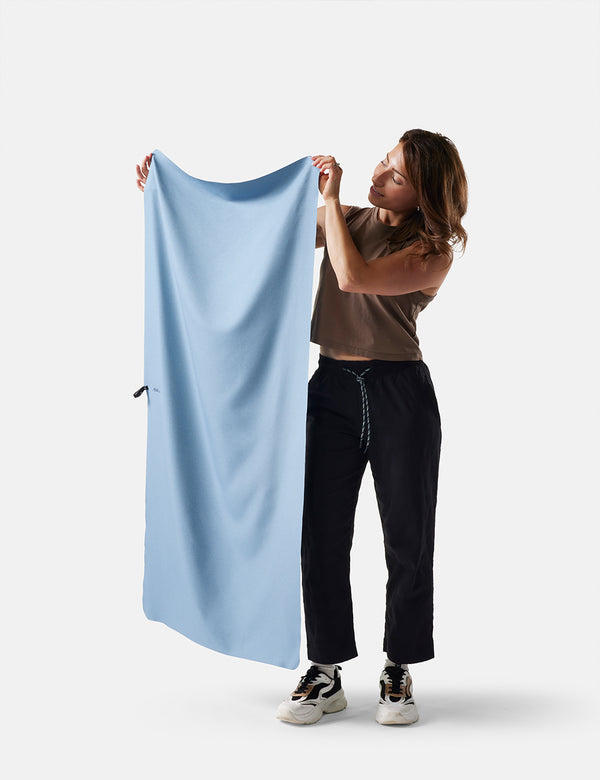 Person holding a slate towel against a white background