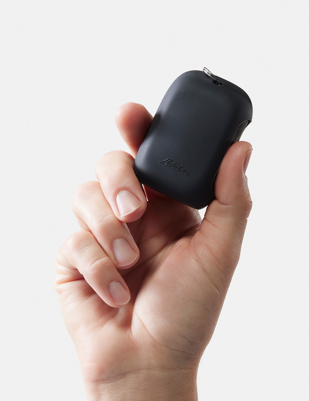 hand holding small towel silicon case on white background