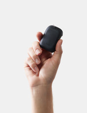 Hand holding a towel case against a light gray background