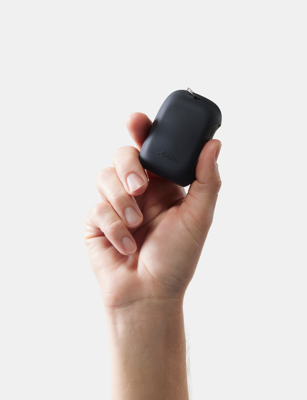 Hand holding a towel case against a light gray background