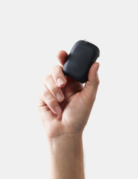 Hand holding a towel case against a light gray background
