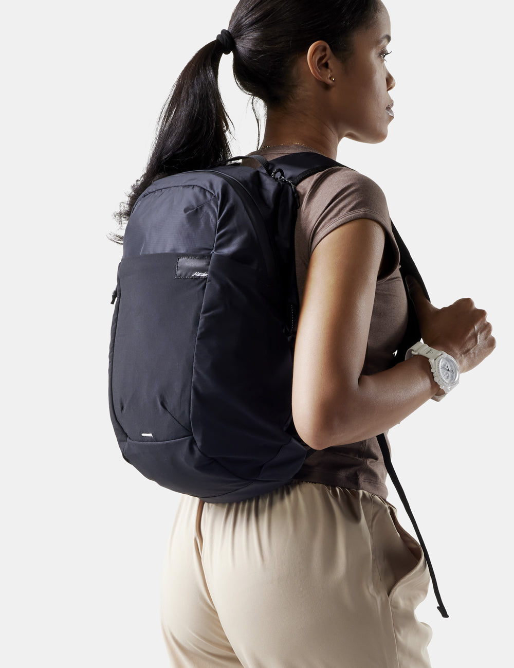 woman on white background wearing black backpac