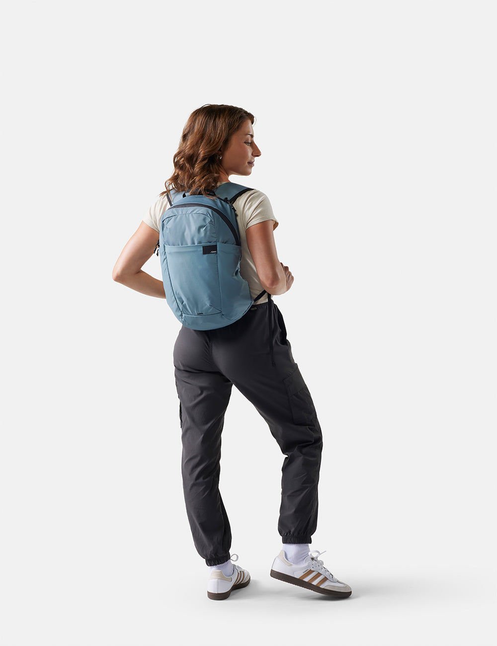 Person wearing a blue backpack on a white background