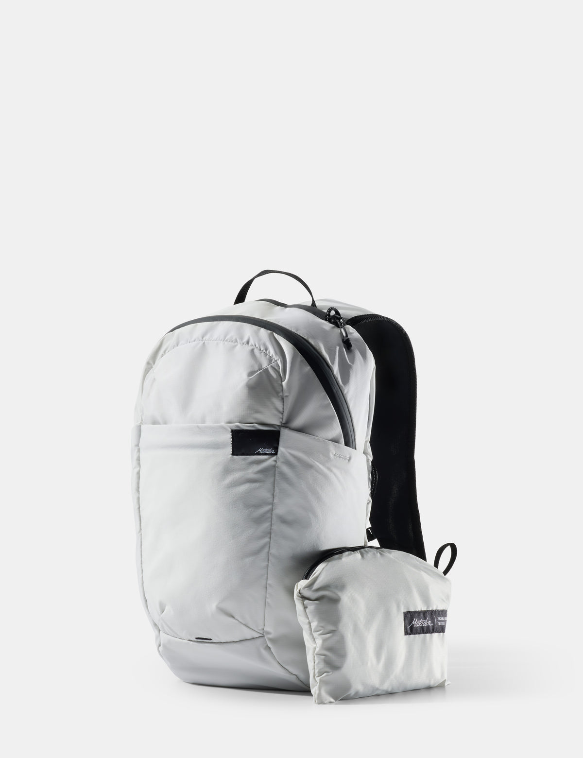 Light gray backpack with a smaller pack attached on a white background