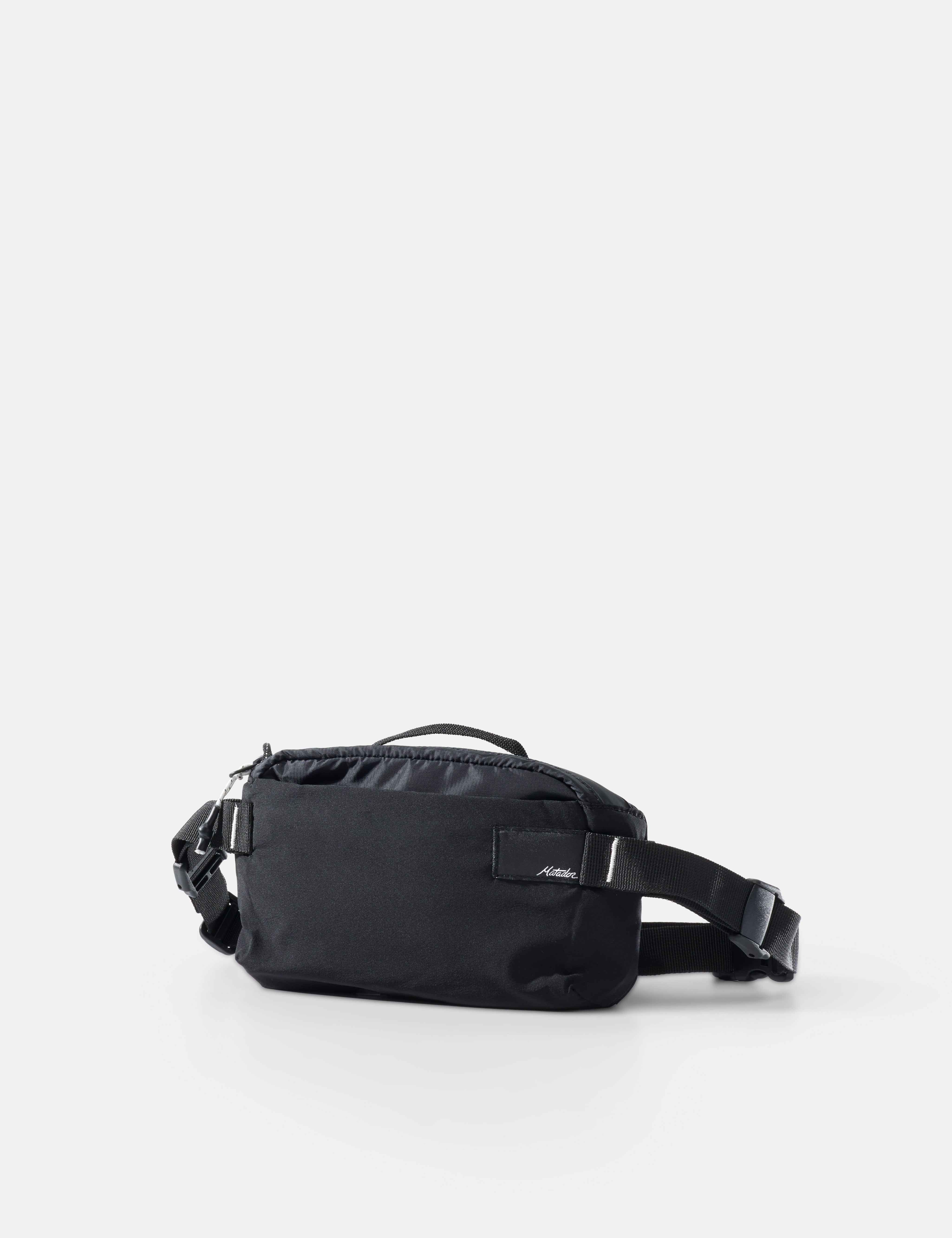 Black waist bag on a light gray background