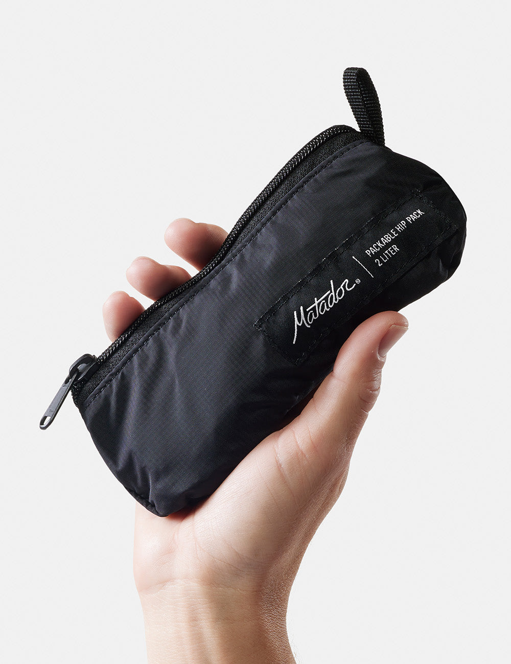 hand holding black, packed-up sling