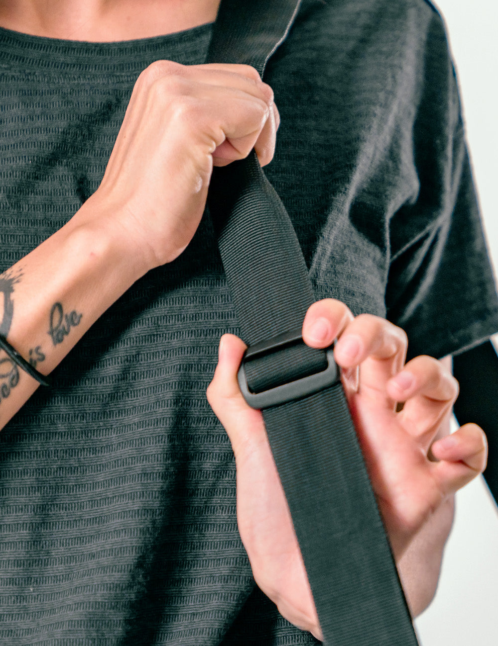 woman&#39;s hands showing adjustable duffle strap