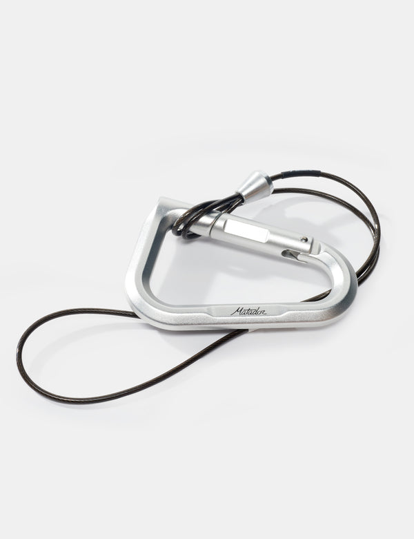 Silver carabiner with a black cord on a white background