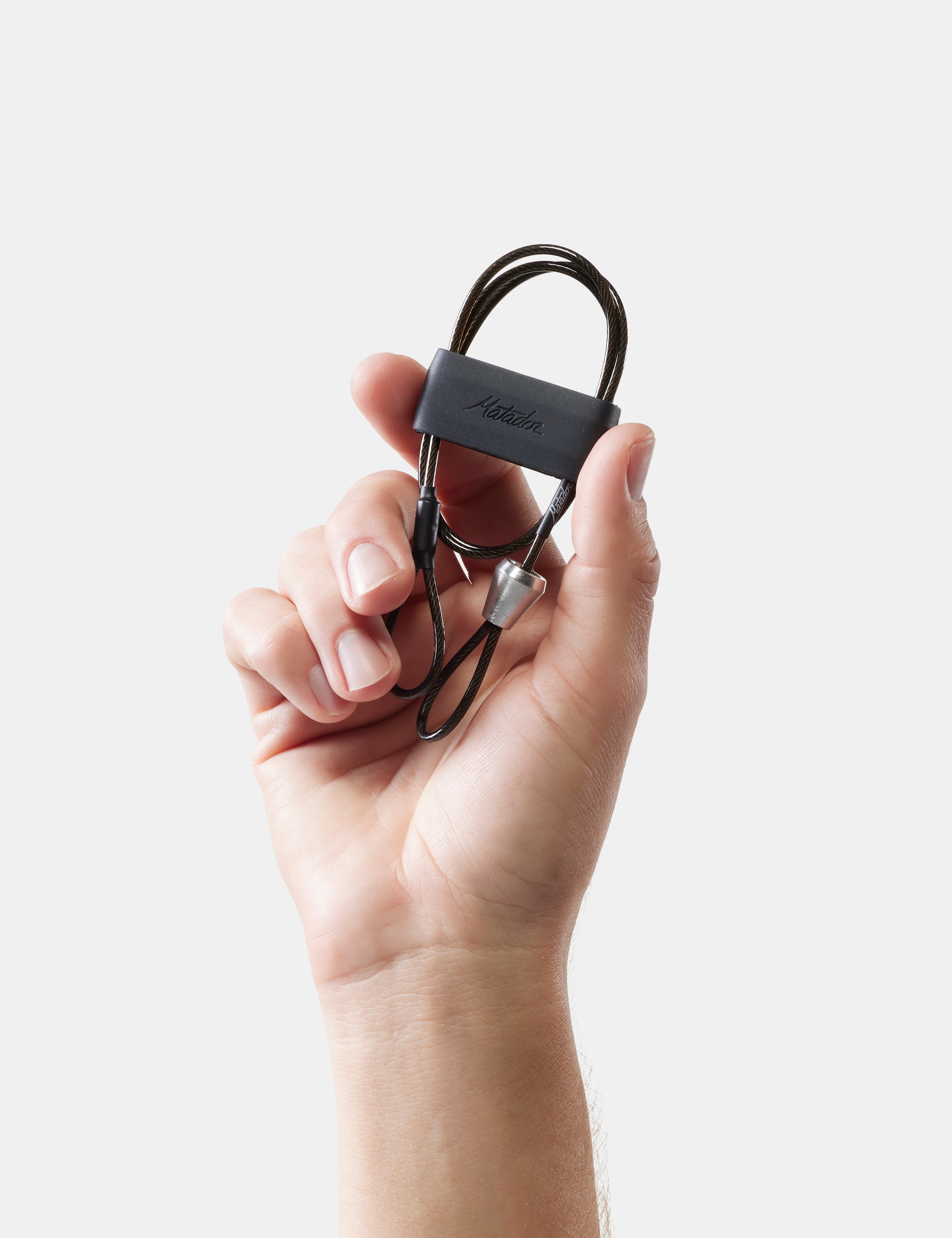 Hand holding a black cable with a visible brand logo against a light background