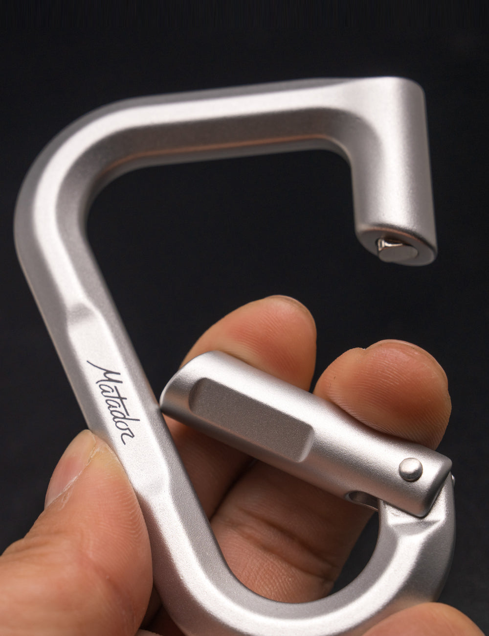 close up view of open carabiner gate