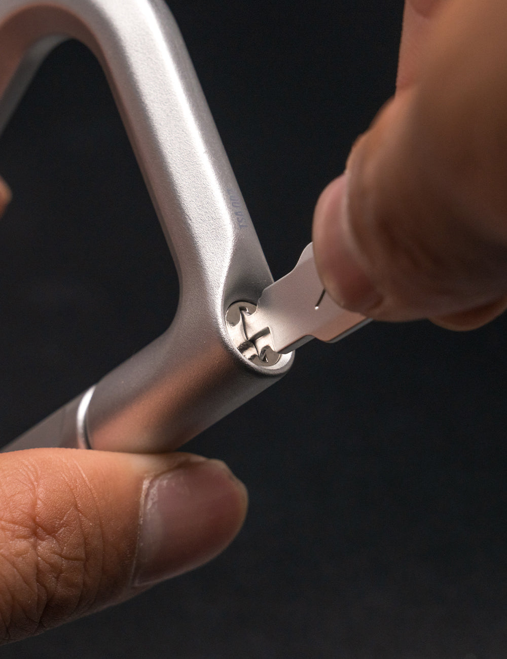 close up view of key going into carabiner lock