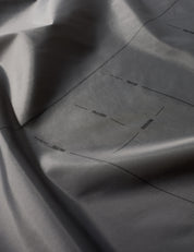 Close-up of gray fabric with subtle texture and folds