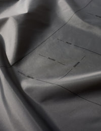 Close-up of gray fabric with subtle texture and folds