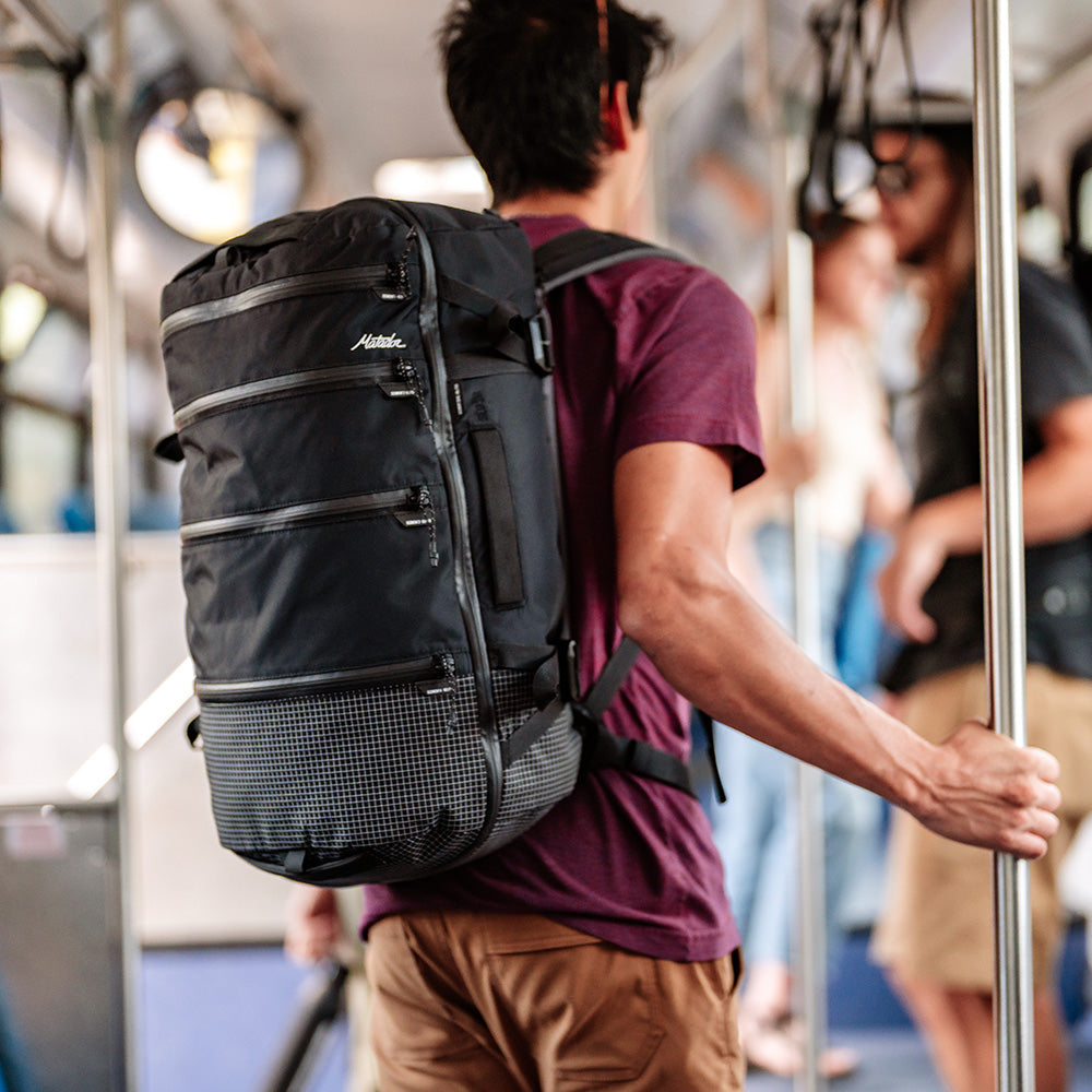 man on public train wearing black seg28