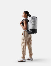 Person wearing a large backpack on a white background