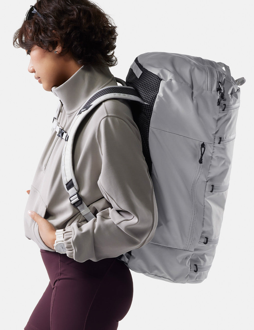 side profile of woman wearing white backpack