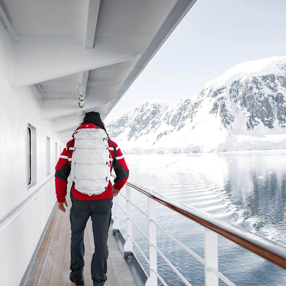 person in red jacket on arctic ship, wearing white seg45