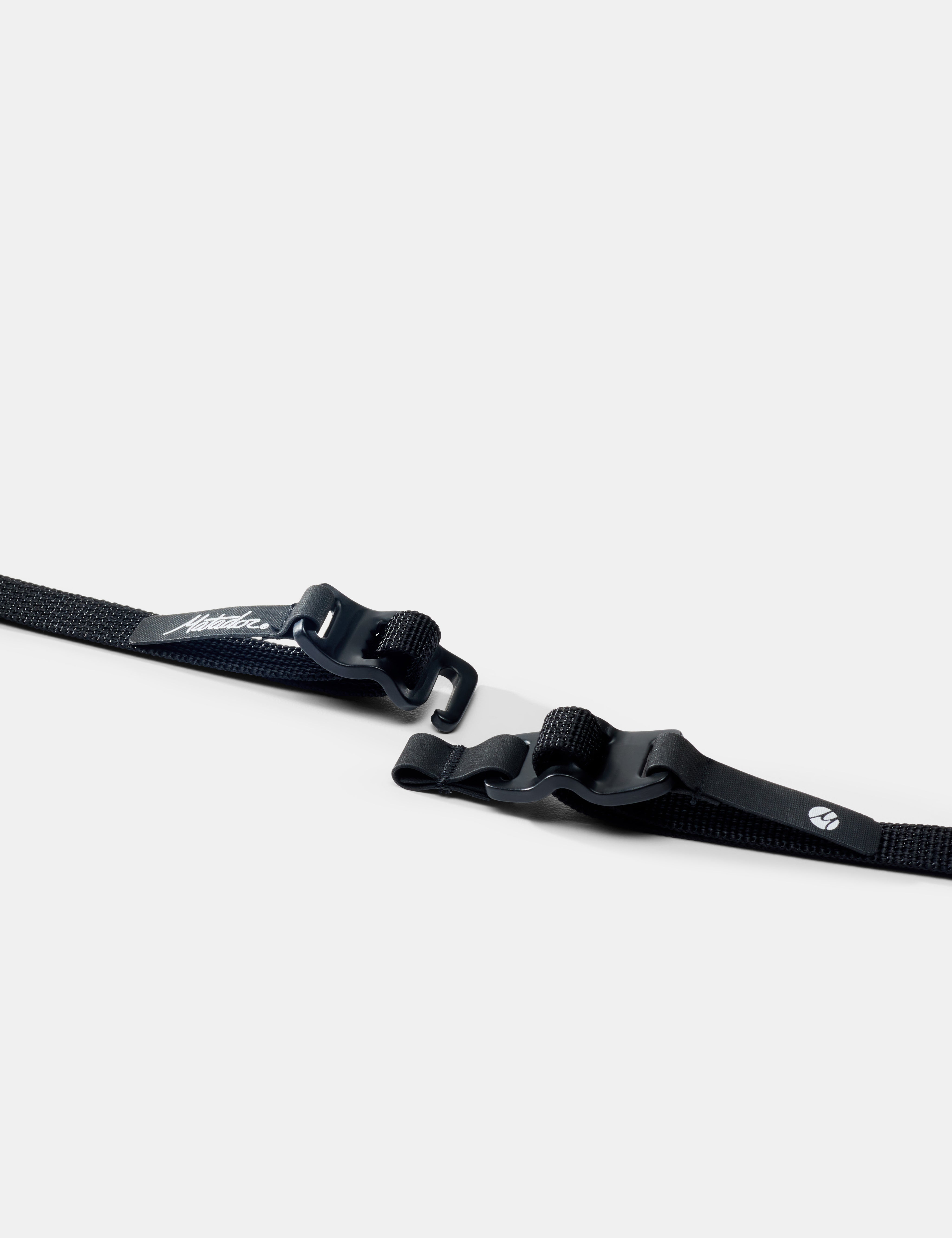 Two black straps with buckles on a white background