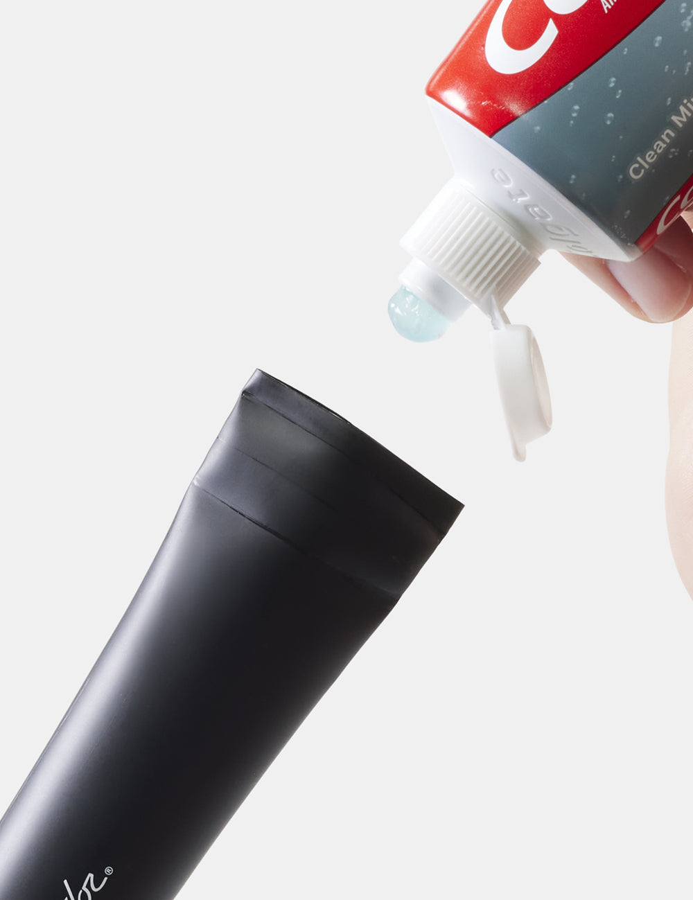 toothpaste being added to a toothpaste tube