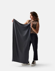 Woman holding gray fabric against a white background
