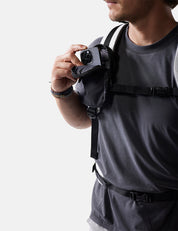 man placing phone into black speed stash on white background
