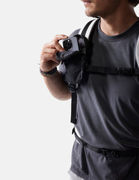 man placing phone into black speed stash on white background