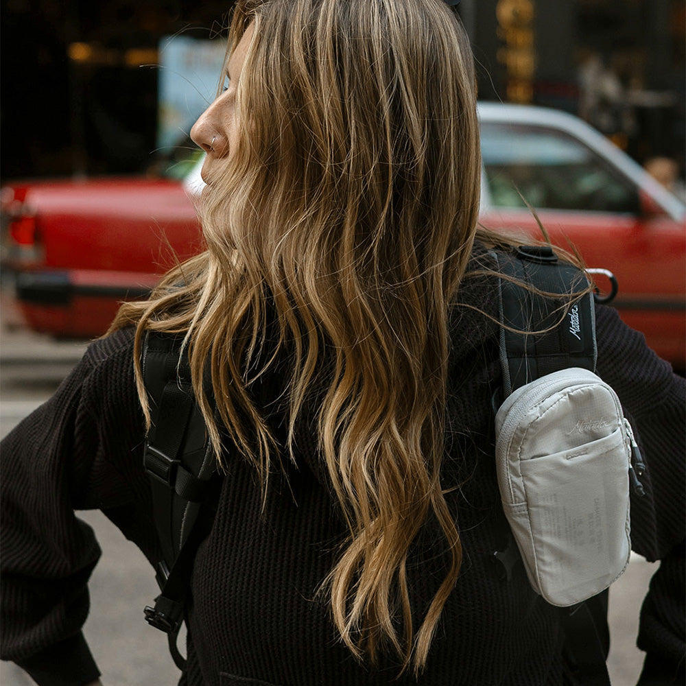 Woman on street, wearing white speed stash