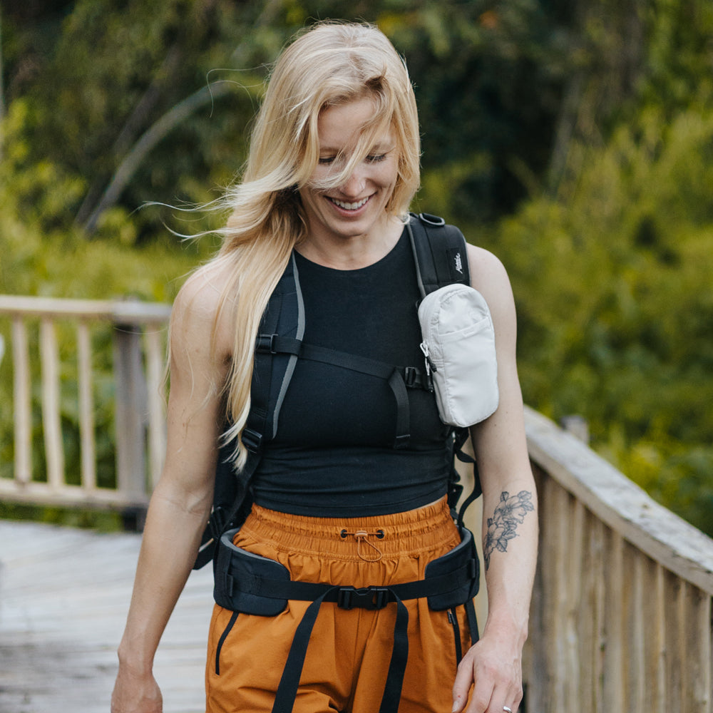 woman walking on tropical boardwalk wearing white speed stash