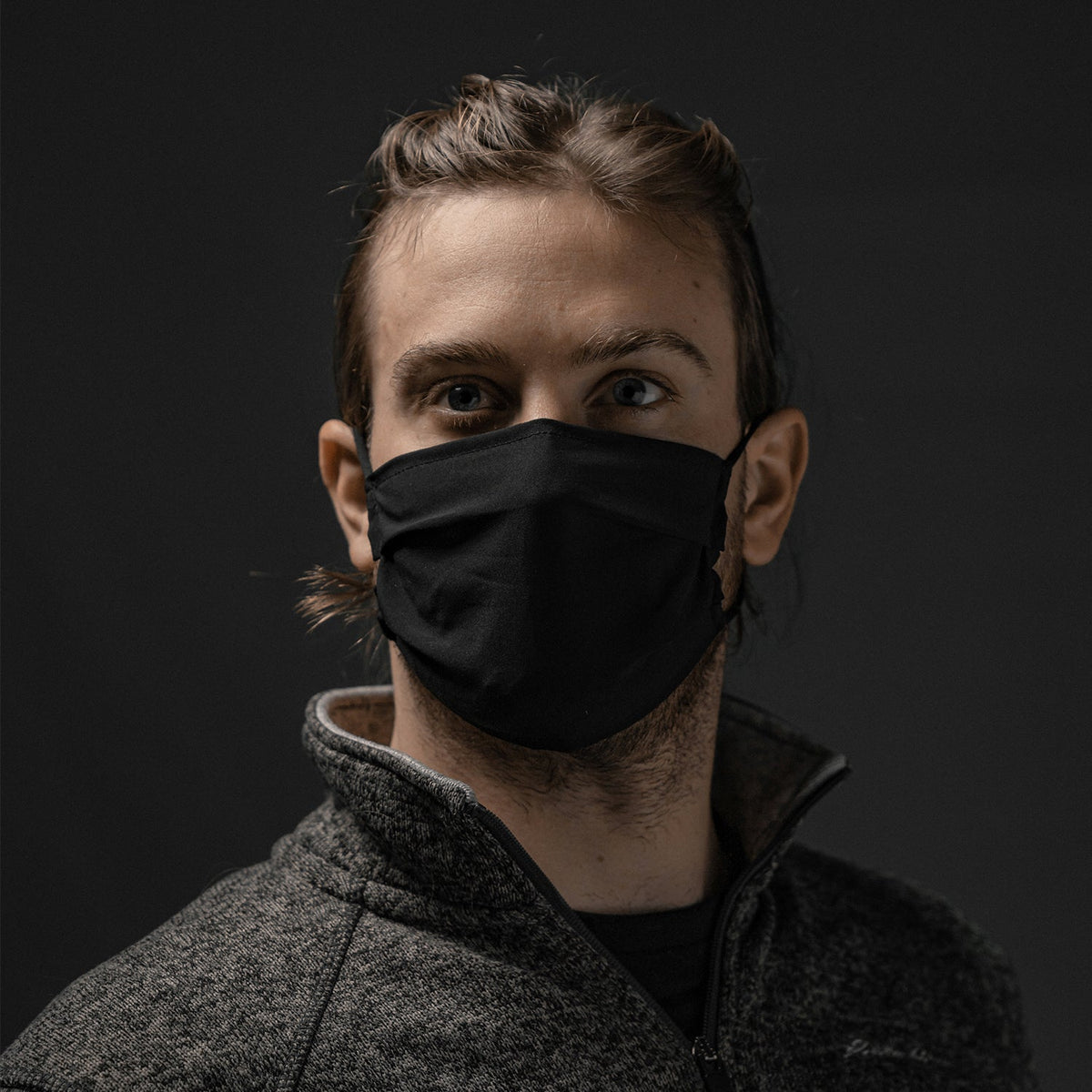 Man facing forward wearing black face mask