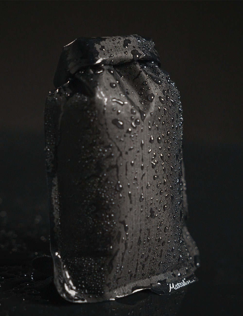 black soap bar case covered in beaded water