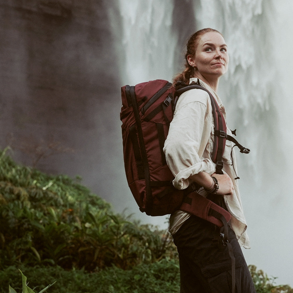 woman wearing garnet globerider35 near waterfall