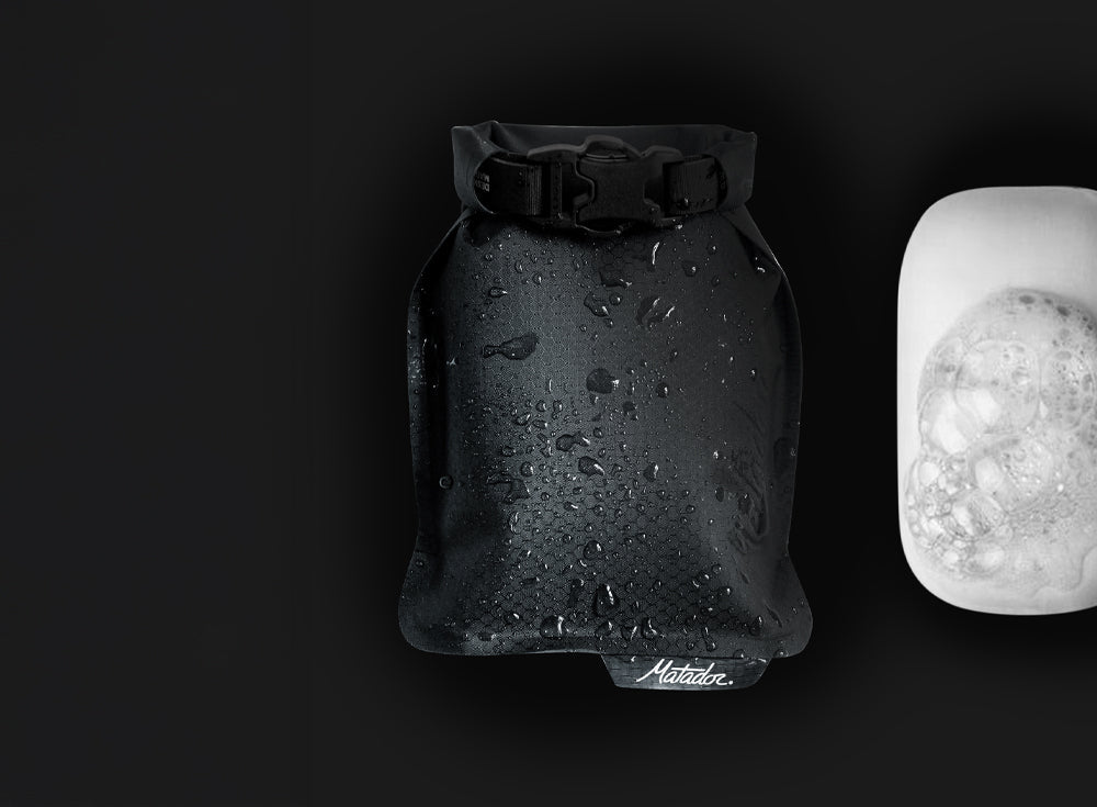 black soap bar case and sudsy white soap on black background