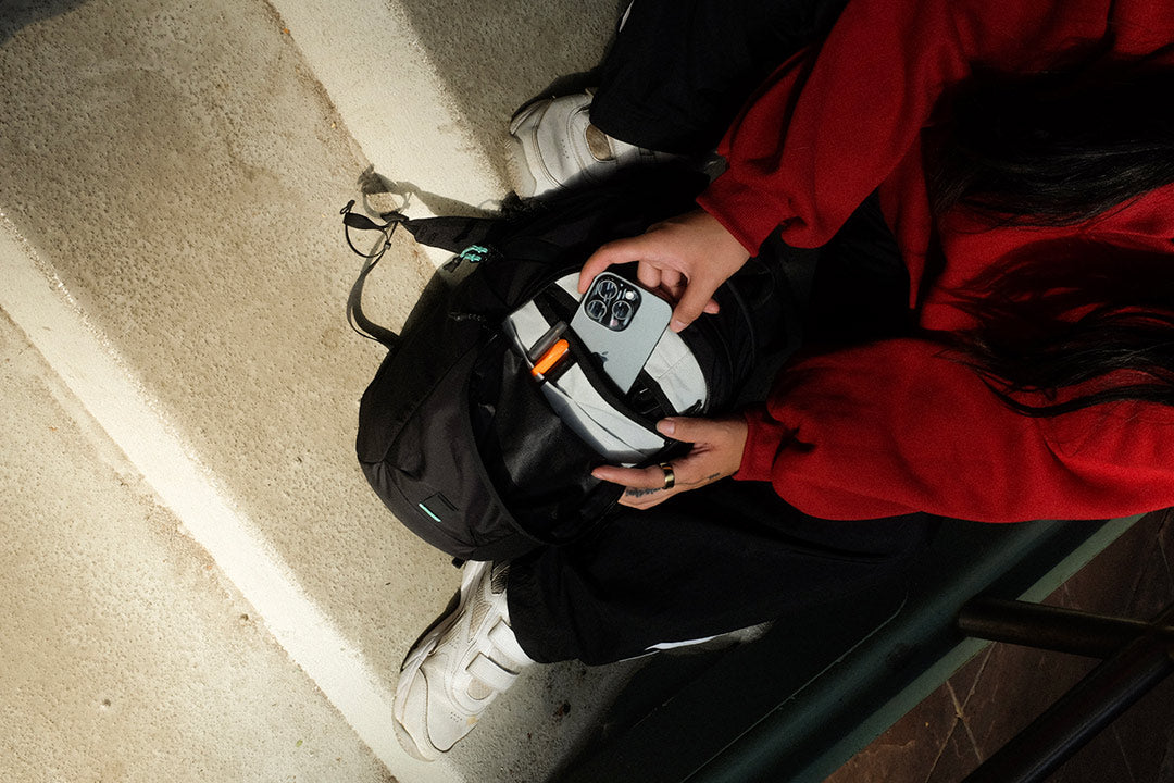 person taking a phone out of a bag