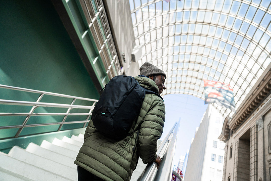 man walking up stairs with a backpack on